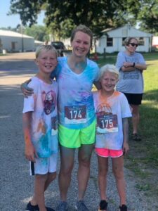 three messy people after completing a color run